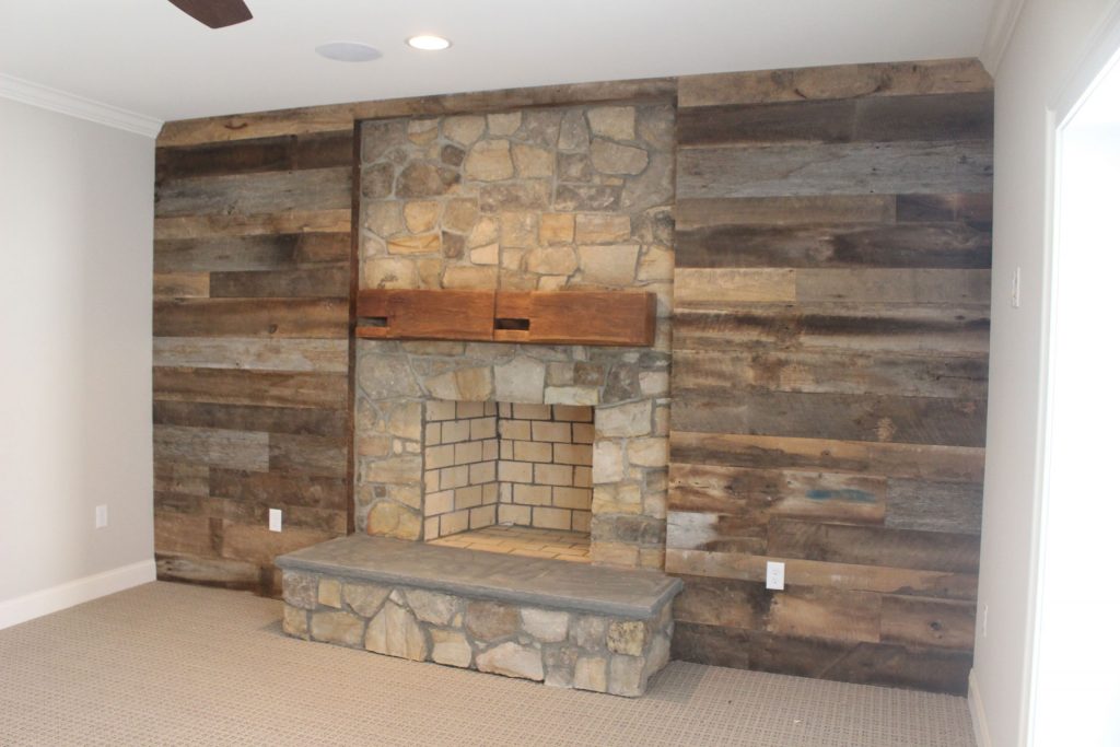 Warfield Homes fireplace mantel and barnwood wall